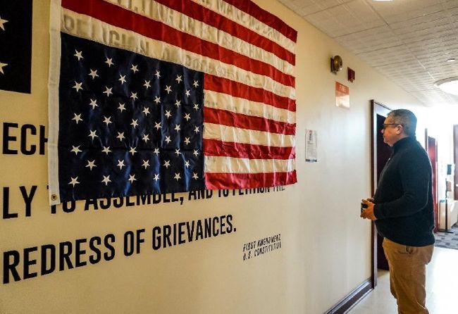 American flag hangs up-side-down in Martin Hall as a distress signal