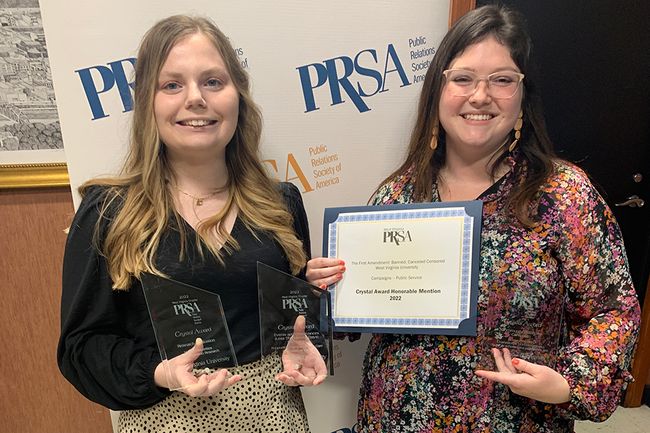 Oakes and Johnson pose with PRSA awards
