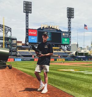Male student standing on a baseball field 