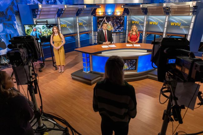 A group of students in a television news studio