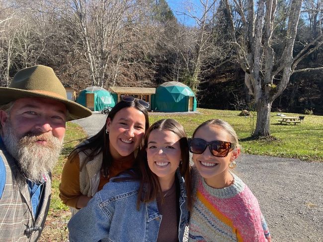 Capstone students Payton Litton, Paige McElroy and Emily Yoder are pictured with the owner of the WV Glamping Domes, Timothy Luce. 