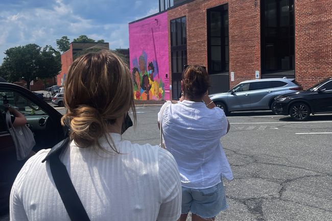 Students photograph mural in Anacostia