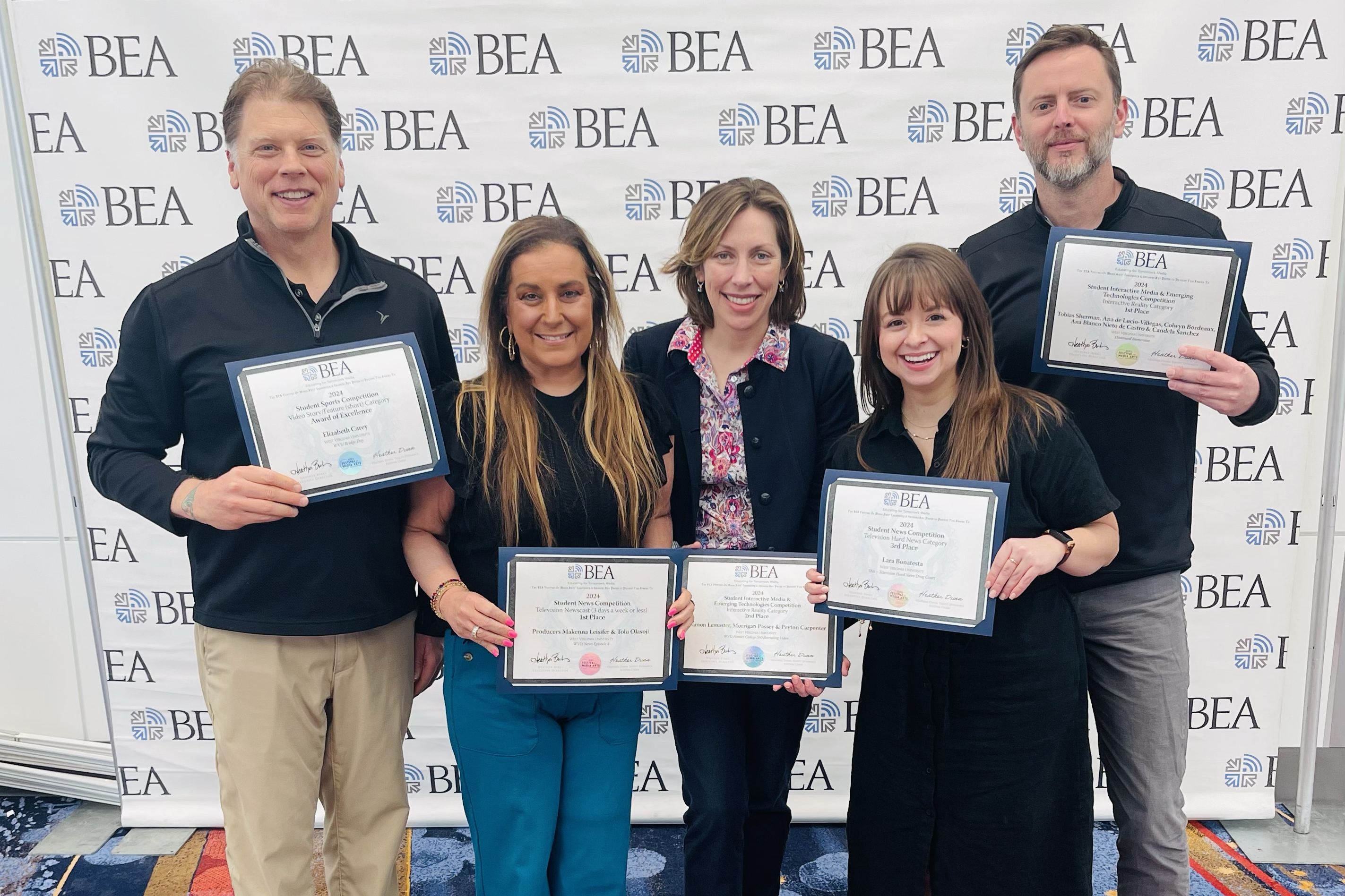 College faculty pose with BEA awards